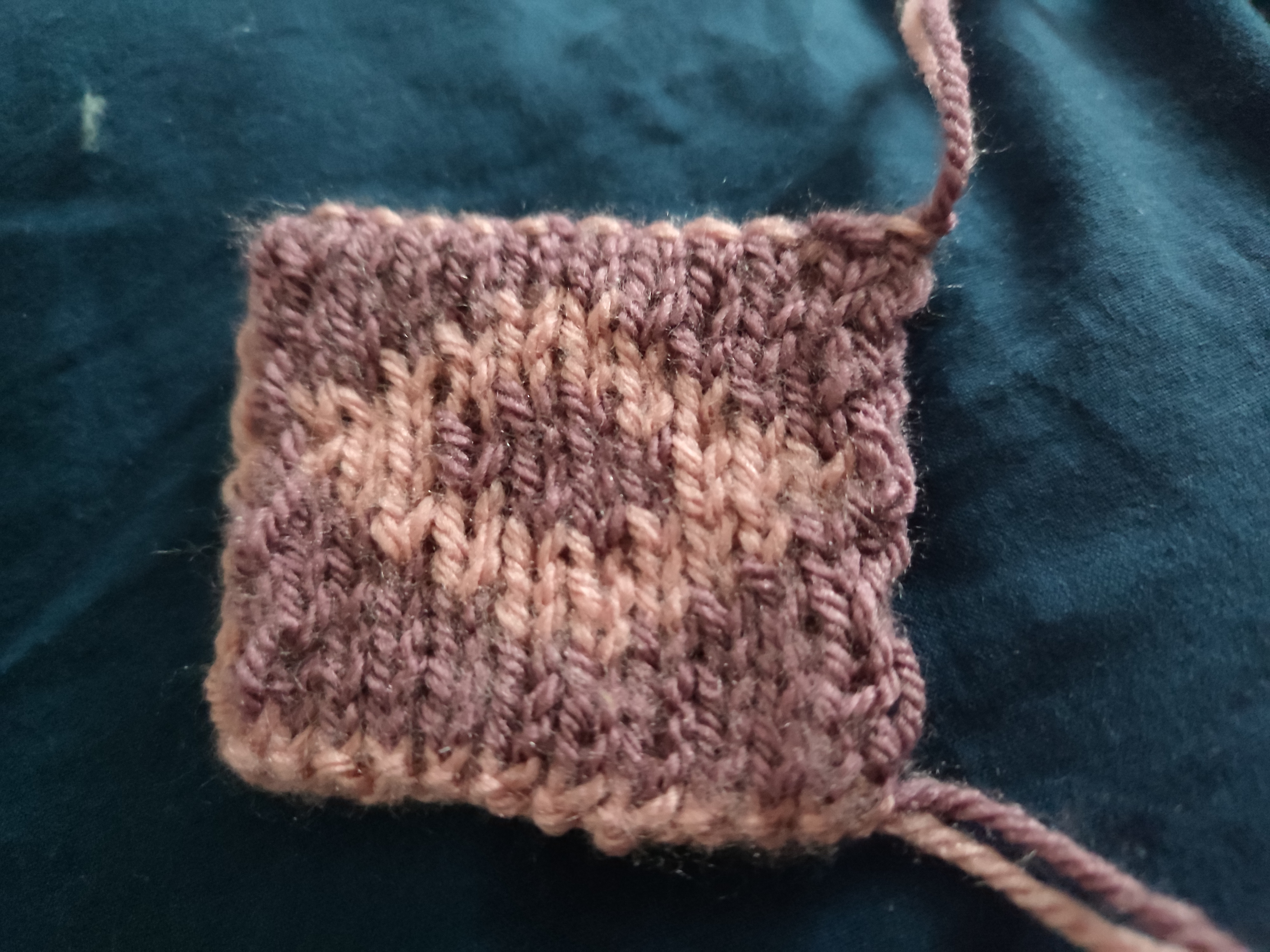 a sort of squished diamond shape in muted pink on a muted purple background