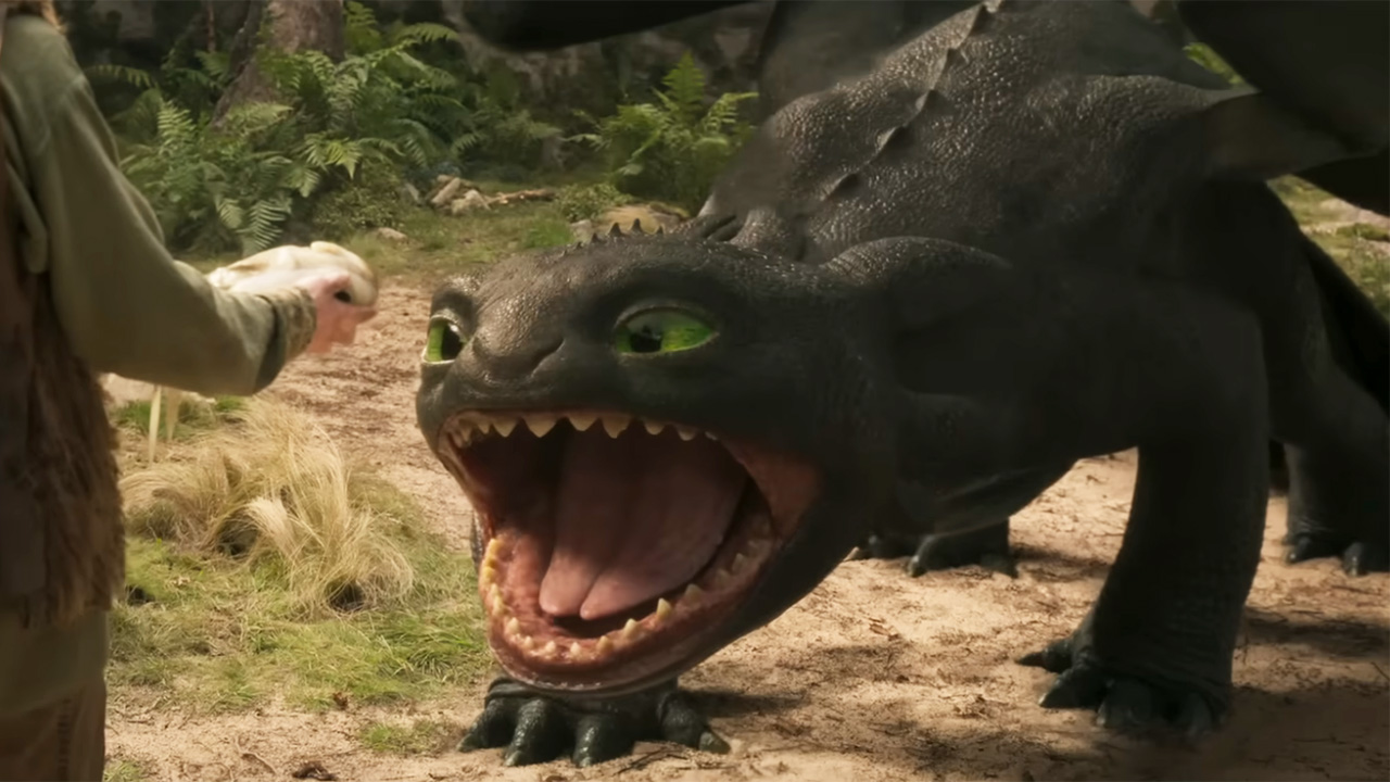 Toothless opening his mouth to eat fish, showing his teeth for the first time.
